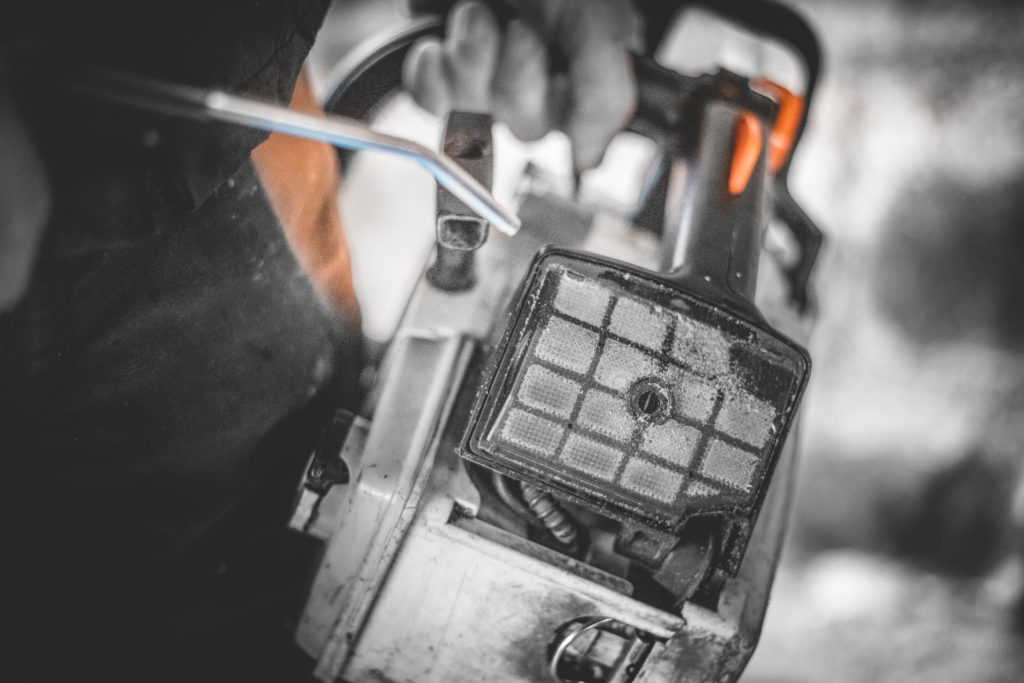 Close-up of a chainsaw filter being cleaned