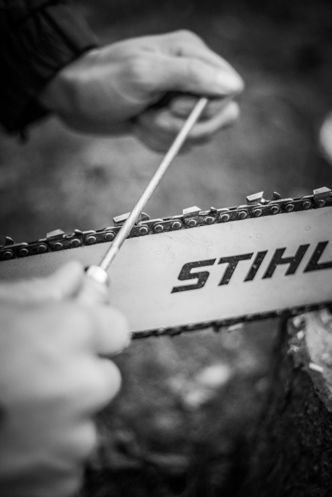 Close-up of a chainsaw being sharpened